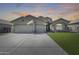 Charming single-story home featuring a three-car garage, stone accents and a well-manicured lawn at 854 S Del Rio Ct, Apache Junction, AZ 85120