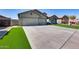 Single-Gathering home with a three-car garage, stone accents and a well-maintained front lawn at 854 S Del Rio Ct, Apache Junction, AZ 85120