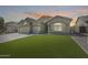 Charming single-story home featuring a stone facade accent, pristine lawn, and a spacious three-car garage at 854 S Del Rio Ct, Apache Junction, AZ 85120