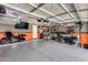 Spacious garage with epoxy flooring, equipped with ample storage and a mounted TV at 854 S Del Rio Ct, Apache Junction, AZ 85120