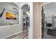 Elegant hallway with wood-look flooring, decorative arches, and contemporary lighting, leading to various rooms at 854 S Del Rio Ct, Apache Junction, AZ 85120