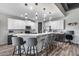 Bright kitchen boasts a large island with seating, stainless steel appliances, and modern pendant lighting at 854 S Del Rio Ct, Apache Junction, AZ 85120
