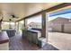 Covered patio with built-in grill, bar, and comfortable seating, perfect for outdoor entertaining at 854 S Del Rio Ct, Apache Junction, AZ 85120