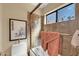 Bathroom featuring walk-in shower, framed artwork and window at 8935 E Larkspur Dr, Scottsdale, AZ 85260