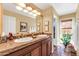 Bathroom with dual sinks, marble countertops, and natural light at 8935 E Larkspur Dr, Scottsdale, AZ 85260