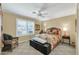 Bedroom with ceiling fan, plantation shutters and seating area at 8935 E Larkspur Dr, Scottsdale, AZ 85260