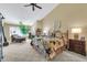 Spacious bedroom with high ceilings, ceiling fan, chaise lounge, and neutral color palette at 8935 E Larkspur Dr, Scottsdale, AZ 85260