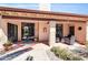 Inviting covered patio with stylish furniture, decorative lights and sliding glass doors to blend indoor/outdoor living at 8935 E Larkspur Dr, Scottsdale, AZ 85260