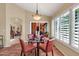 Intimate dining area featuring a glass table, seating for four, and shuttered windows at 8935 E Larkspur Dr, Scottsdale, AZ 85260
