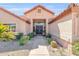 Close-up of the home's inviting entrance, featuring a tile walkway with stone landscaping at 8935 E Larkspur Dr, Scottsdale, AZ 85260