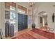 Grand foyer featuring tile flooring, a chandelier, and a double-door entrance with ample natural light at 8935 E Larkspur Dr, Scottsdale, AZ 85260