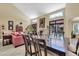 Bright living room with tile floors, a fireplace, a dining table, and large windows at 8935 E Larkspur Dr, Scottsdale, AZ 85260