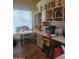 Bright home office with extensive built-in shelving and storage at 8935 E Larkspur Dr, Scottsdale, AZ 85260