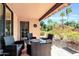 Cozy outdoor patio with comfortable seating, a fire pit table, and views of the lush backyard at 8935 E Larkspur Dr, Scottsdale, AZ 85260