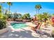 Beautiful backyard pool area featuring chaise lounges, a pergola, and mature tropical landscaping at 8935 E Larkspur Dr, Scottsdale, AZ 85260