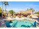 Stunning pool area surrounded by lush landscaping, patio furniture, and mature palm trees at 8935 E Larkspur Dr, Scottsdale, AZ 85260