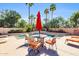 Inviting pool area featuring outdoor seating, a dining table, and lush tropical landscaping at 8935 E Larkspur Dr, Scottsdale, AZ 85260