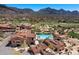 Aerial view of community pool and surrounding desert landscape with golf course and mountain views at 9270 E Thompson Peak Pkwy # 381, Scottsdale, AZ 85255