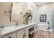 Bright bathroom with dual sinks, vanity, soaking tub, and white cabinets at 9270 E Thompson Peak Pkwy # 381, Scottsdale, AZ 85255