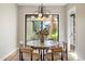 Elegant dining room featuring a stylish light fixture, marble table, and lush outdoor views at 9270 E Thompson Peak Pkwy # 381, Scottsdale, AZ 85255