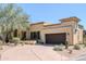 Exterior of a desert home with a large driveway and a two-car garage at 9270 E Thompson Peak Pkwy # 381, Scottsdale, AZ 85255