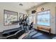 Well-lit gym with exercise machines, large windows, and views of the outdoor community pool at 9270 E Thompson Peak Pkwy # 381, Scottsdale, AZ 85255