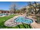 Inviting community hot tub with blue and white tiles and surrounding greenery on a sunny day at 9270 E Thompson Peak Pkwy # 381, Scottsdale, AZ 85255