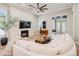 Bright living room featuring a fireplace, modern ceiling fan, and access to the backyard at 9270 E Thompson Peak Pkwy # 381, Scottsdale, AZ 85255