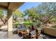 Outdoor seating area with black patio furniture and views of trees at 9270 E Thompson Peak Pkwy # 381, Scottsdale, AZ 85255