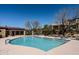 Bright community pool with blue water, lounge chairs, and beautiful landscaping on a sunny day at 9270 E Thompson Peak Pkwy # 381, Scottsdale, AZ 85255