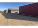 Property exterior with a metal building and a quaint house, offering a blend of functionality and residential comfort at 9600 S 393Rd Ave, Tonopah, AZ 85354