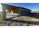 A close exterior shot of the block building's construction, detailing the concrete patio and attached wooden awning at 9600 S 393Rd Ave, Tonopah, AZ 85354