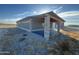 View of the exterior of the single story block building showing the covered front patio at 9600 S 393Rd Ave, Tonopah, AZ 85354