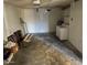 Unfinished garage, with a laundry area, a cement floor and overhead lighting at 9638 W Cinnabar Ave # B, Peoria, AZ 85345