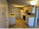 Functional kitchen with a white refrigerator, tile flooring, range and ample cabinet space for storage at 9638 W Cinnabar Ave # B, Peoria, AZ 85345