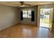 Inviting living room featuring wood floors, a ceiling fan, and a view through the window to the outside at 9638 W Cinnabar Ave # B, Peoria, AZ 85345