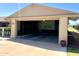 Spacious two-car garage with an open door, showcasing ample parking and storage space with an attached structure at 10327 W Prairie Hills Cir, Sun City, AZ 85351