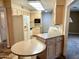 Bright kitchen with updated countertops, plentiful cabinets, and modern appliances including microwave and refrigerator at 10327 W Prairie Hills Cir, Sun City, AZ 85351