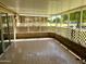 Covered, screened-in patio with a solid flooring and decorative brick accents, offering an excellent outdoor living space at 10327 W Prairie Hills Cir, Sun City, AZ 85351