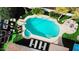 Aerial view of a backyard featuring a pool, lounge chairs, a patio area and manicured desert landscaping at 10640 E Mercer Ln, Scottsdale, AZ 85259