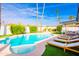 Relaxing backyard with a pristine pool, poolside lounge chairs, and mature landscaping with palm trees at 10640 E Mercer Ln, Scottsdale, AZ 85259