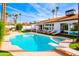 Sunny backyard featuring a swimming pool, attached hot tub, diving board and a variety of seating options at 10640 E Mercer Ln, Scottsdale, AZ 85259