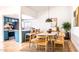 Open dining area with modern lighting, seating for eight, and a view into the updated kitchen at 10640 E Mercer Ln, Scottsdale, AZ 85259