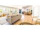 Bright, open-concept living room and dining area with wood floors and modern decor at 10640 E Mercer Ln, Scottsdale, AZ 85259
