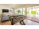 Spacious living area with a foosball table, large sliding glass doors to the backyard, and stylish furniture at 10640 E Mercer Ln, Scottsdale, AZ 85259