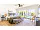 Bright main bedroom with a king bed, plush bedding, and sliding doors to the backyard pool area at 10640 E Mercer Ln, Scottsdale, AZ 85259