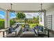 Covered patio featuring stylish outdoor seating, elegant lighting, and a view of the well-maintained backyard at 11878 N Hershey St, Surprise, AZ 85388