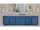 Elegant bathroom featuring double sinks with blue cabinets and stylish backsplash at 11878 N Hershey St, Surprise, AZ 85388