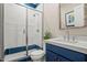 Modern bathroom featuring a glass-enclosed shower and a stylish vanity with a blue cabinet at 11878 N Hershey St, Surprise, AZ 85388