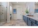 Bathroom with double sink vanity, modern tile, glass enclosed shower, and separate toilet room at 11878 N Hershey St, Surprise, AZ 85388